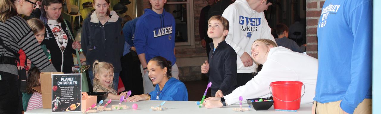 Volunteers at Roger That with kids